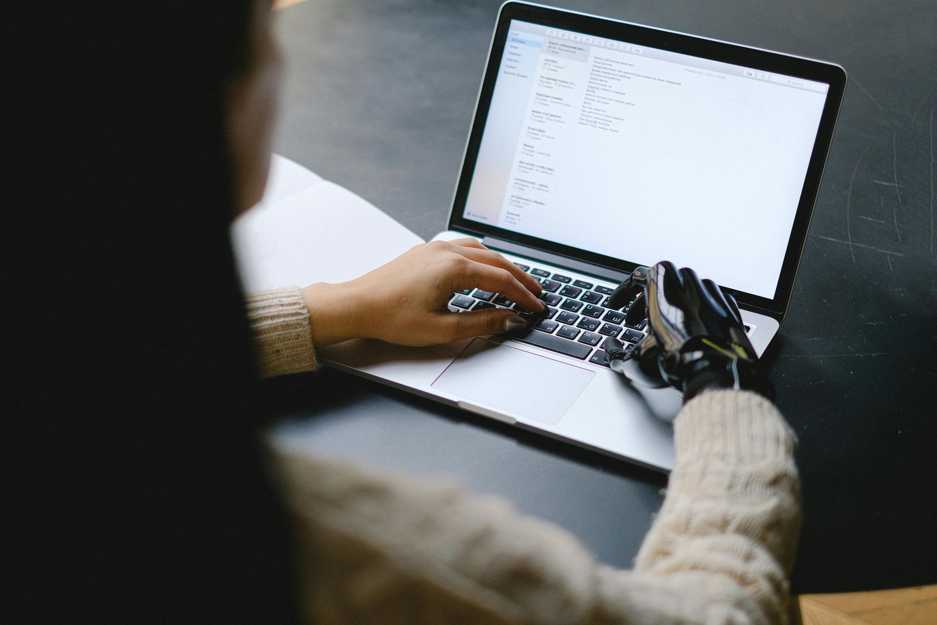 A person is typing on a laptop computer.