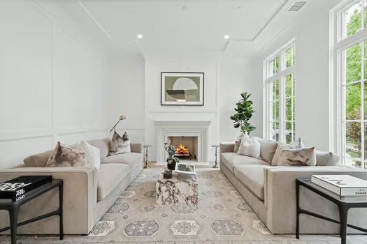 A living room with two couches and a fireplace
