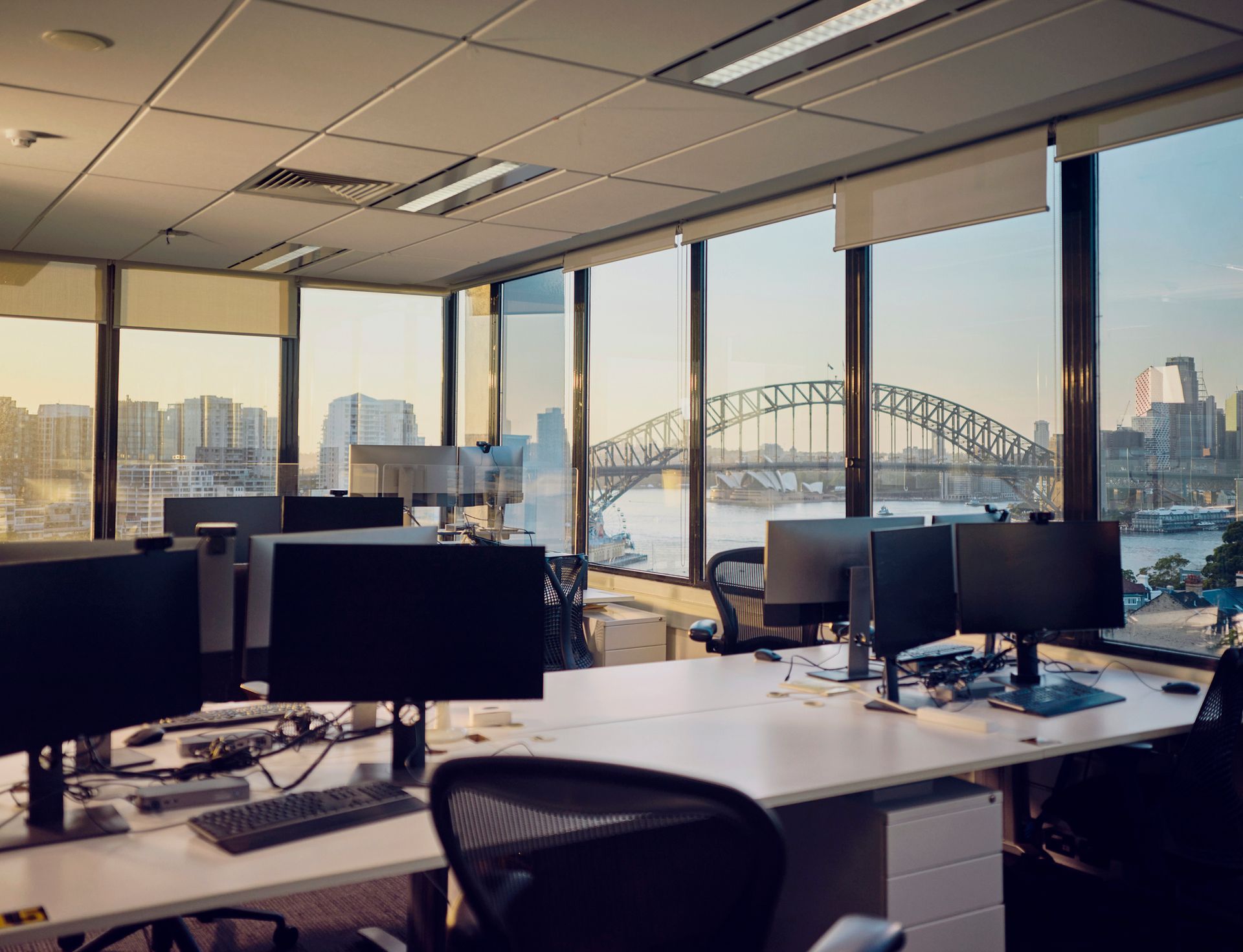 An office with a lot of windows and a view of the harbor.