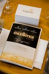 A program for the awards of excellence is sitting on a table.