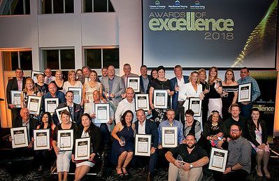 A large group of people are posing for a picture at the awards of excellence.
