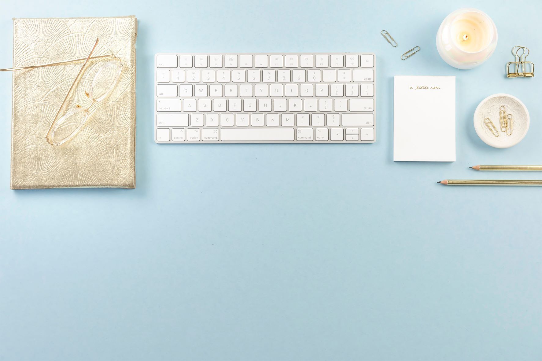 Journal, glasses, keyboard, notes, candle, pencils_Primer & Scout_How to Become a Virtual Assistant