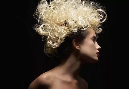 Photo of woman with styled and blond dyed hair for Salon Envy, hair salon in Highland Park, NJ between Edison and New Brunswick.