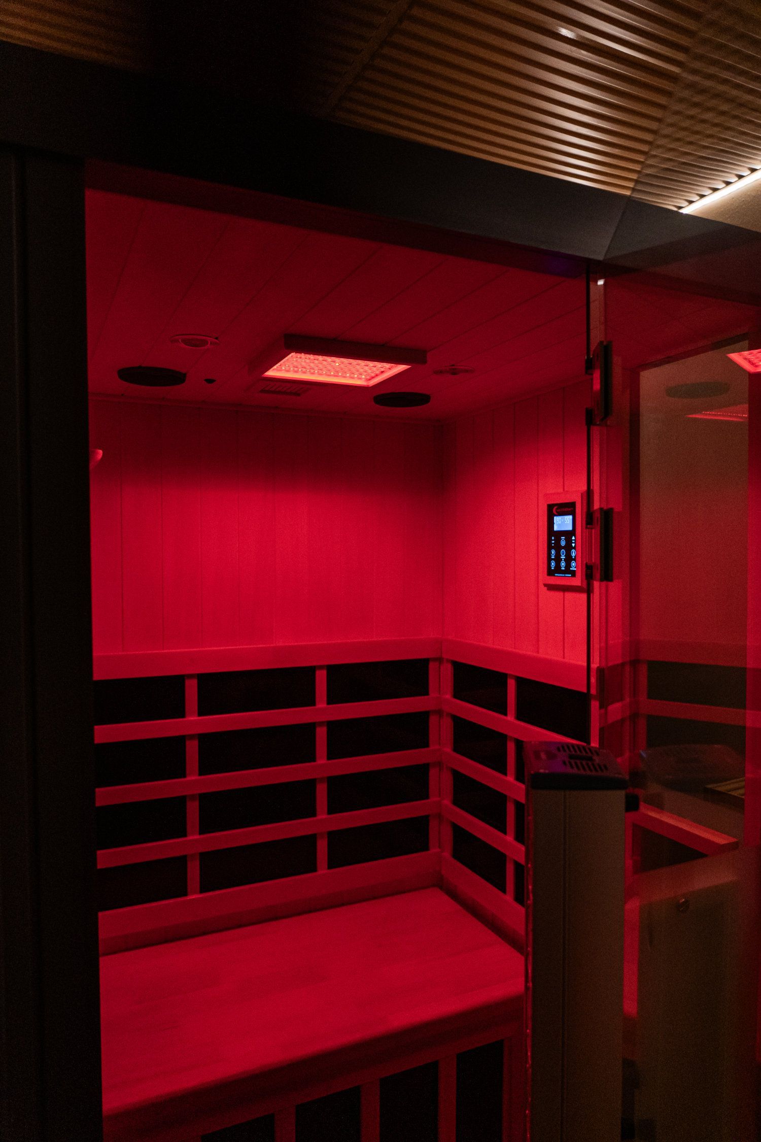 Red light therapy device inside a room, illuminating the space.