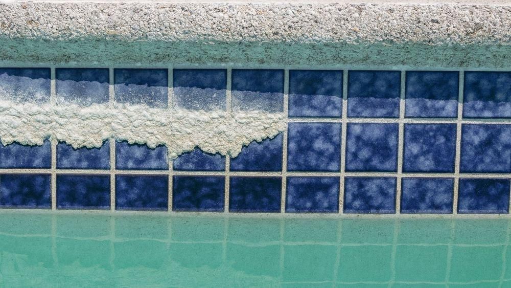 Mineral buildup on natural stone pool coping