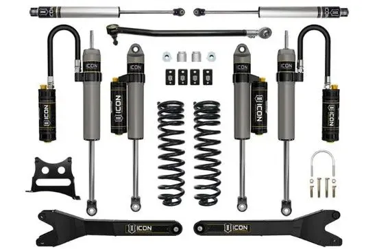 Suspension lift kit parts laid out on white background, including shocks, springs, control arms, and hardware