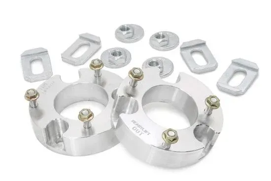 Aluminum wheel spacers with bolts and mounting plates on a white background