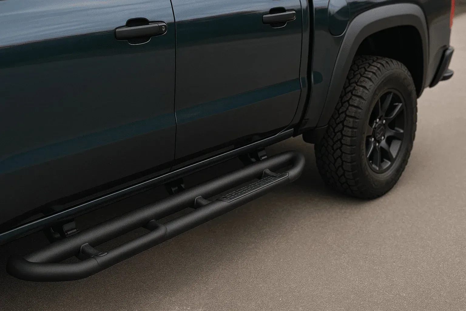 Black pickup truck with side step rails and off-road tires parked on pavement