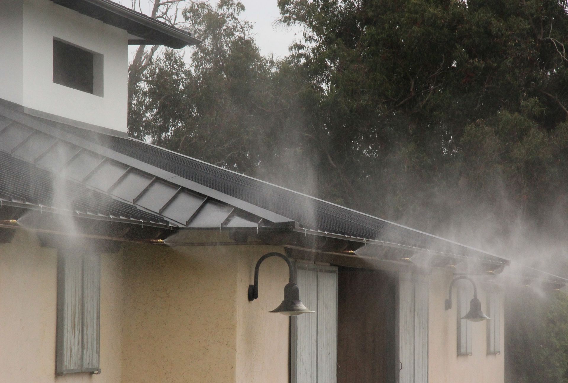 Smoke is coming out of the roof of a house.