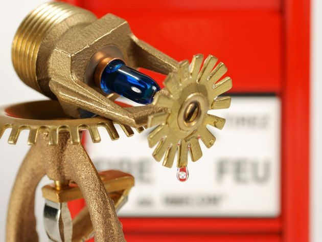 A close up of a fire sprinkler with a red box in the background
