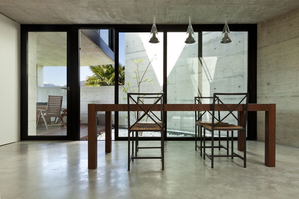 A Dining Room With A Table And Chairs And A Large Window — McGrath Builders & Associates In Albury, NSW