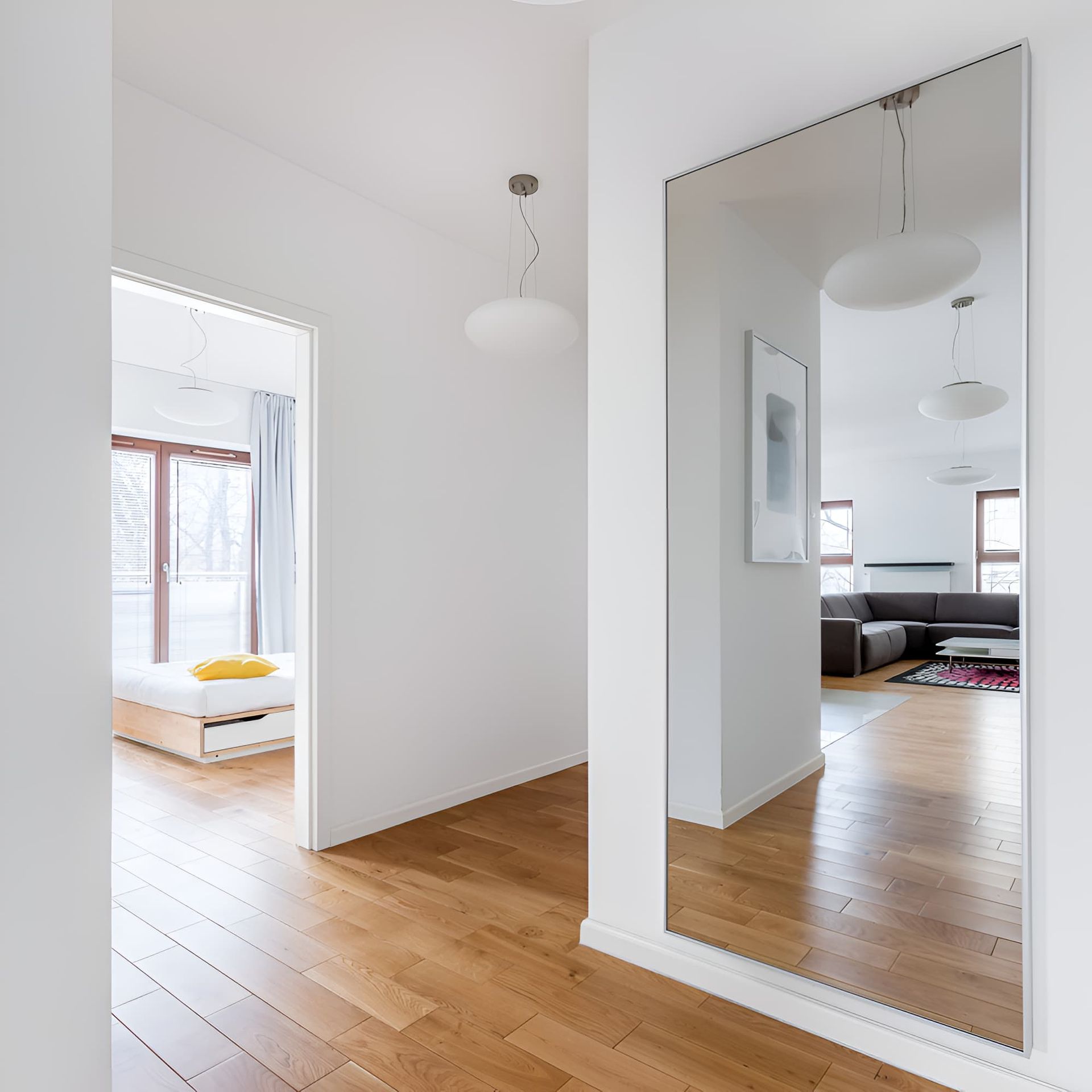 A Large Mirror Is Hanging On A Wall In A Hallway — McGrath Builders & Associates In Lavington, NSW