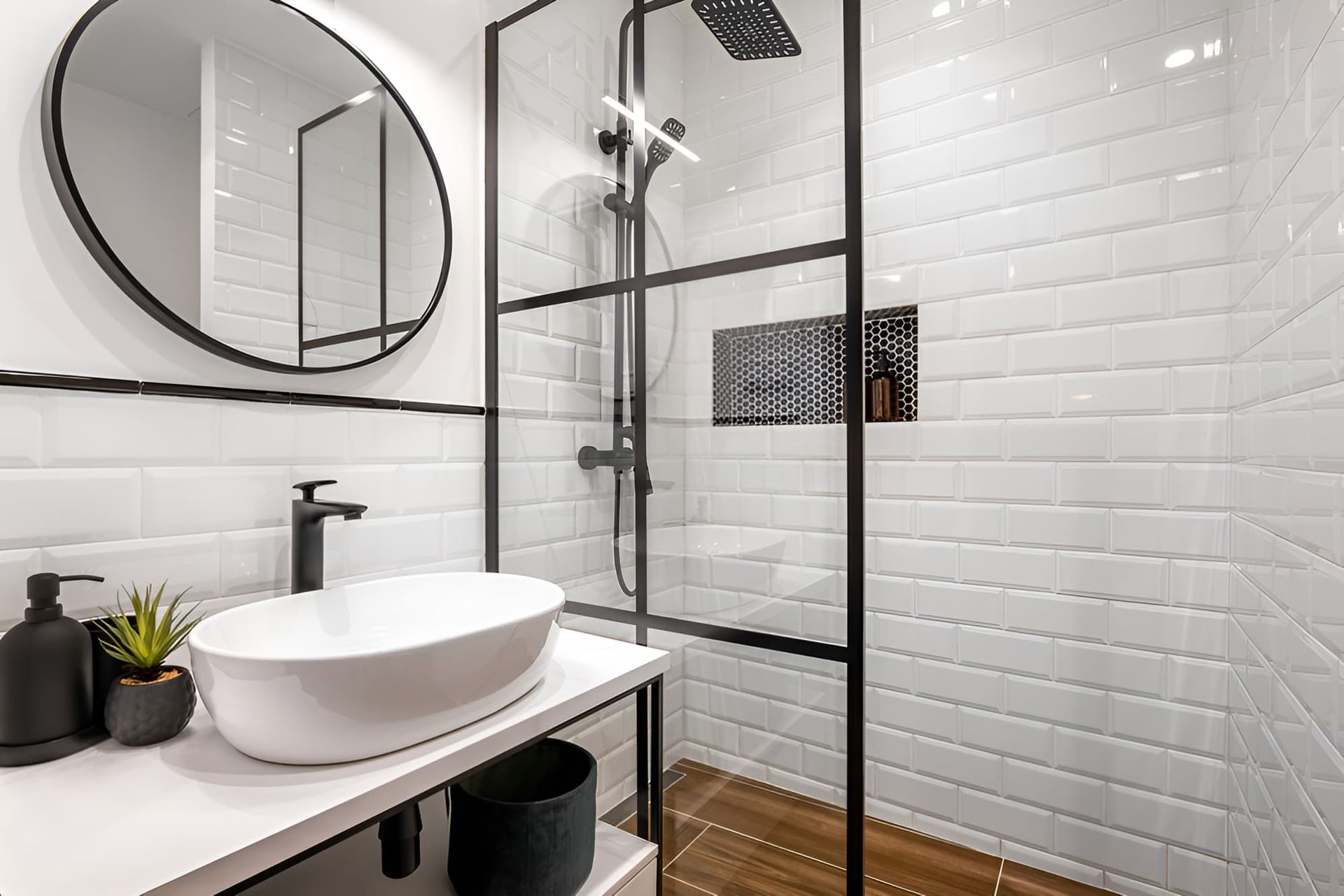Modern bathroom with walk-in shower, vanity sink and mirror by McGrath Builders & Associates in Lavington NSW