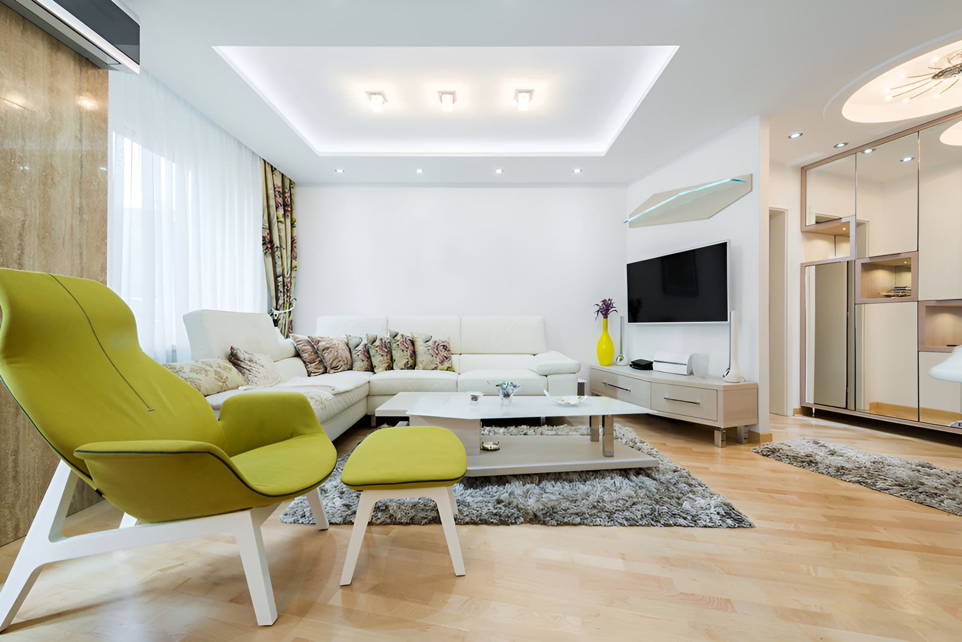 A Living Room With A Couch , Chair , Table And Television — McGrath Builders & Associates In Wodonga, VIC