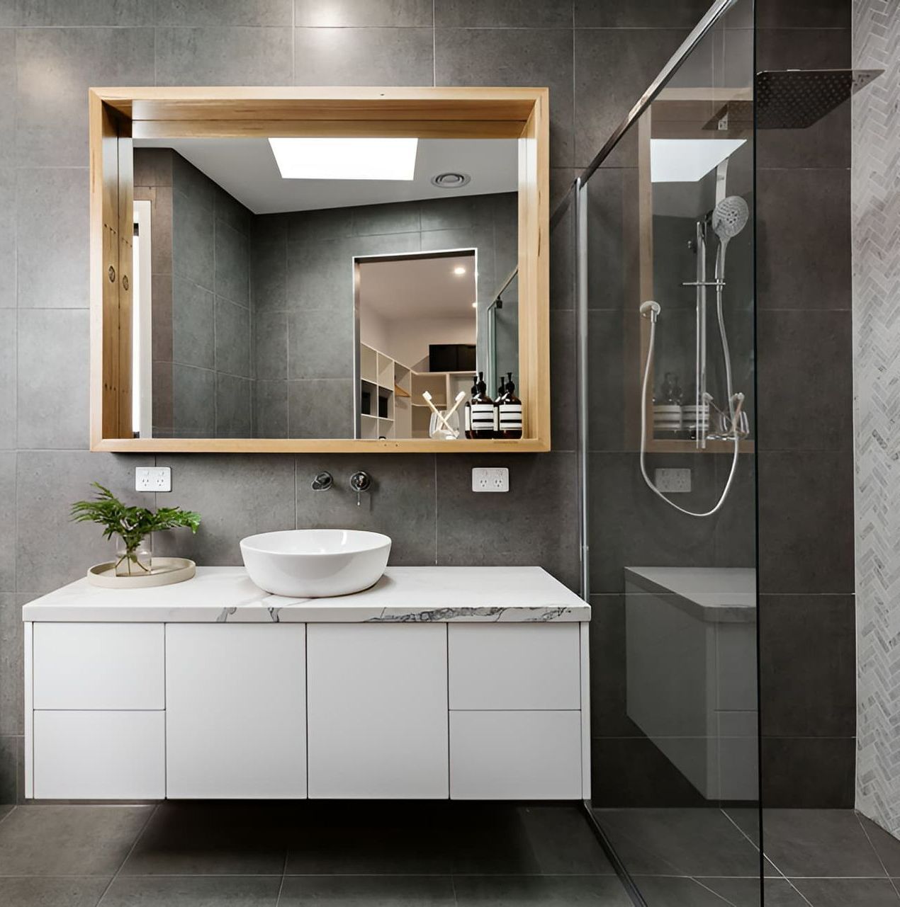 Stylish bathroom with vanity sink, mirror and walk-in shower by McGrath Builders & Associates in Lavington NSW.