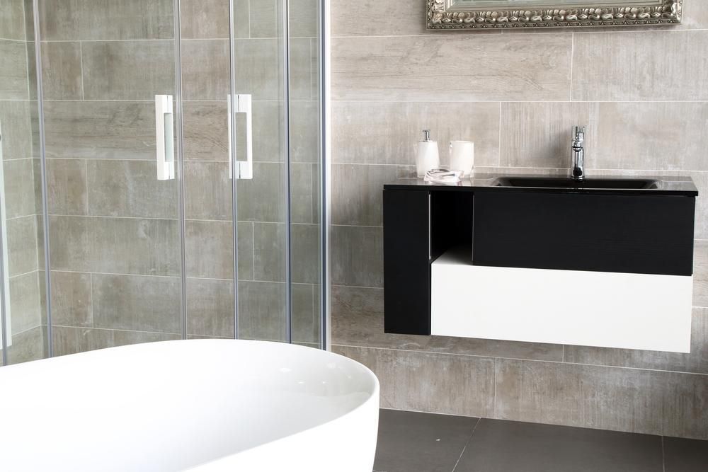 Modern bathroom with black and white vanity, shower and bathtub by McGrath Builders & Associates in Lavington NSW.
