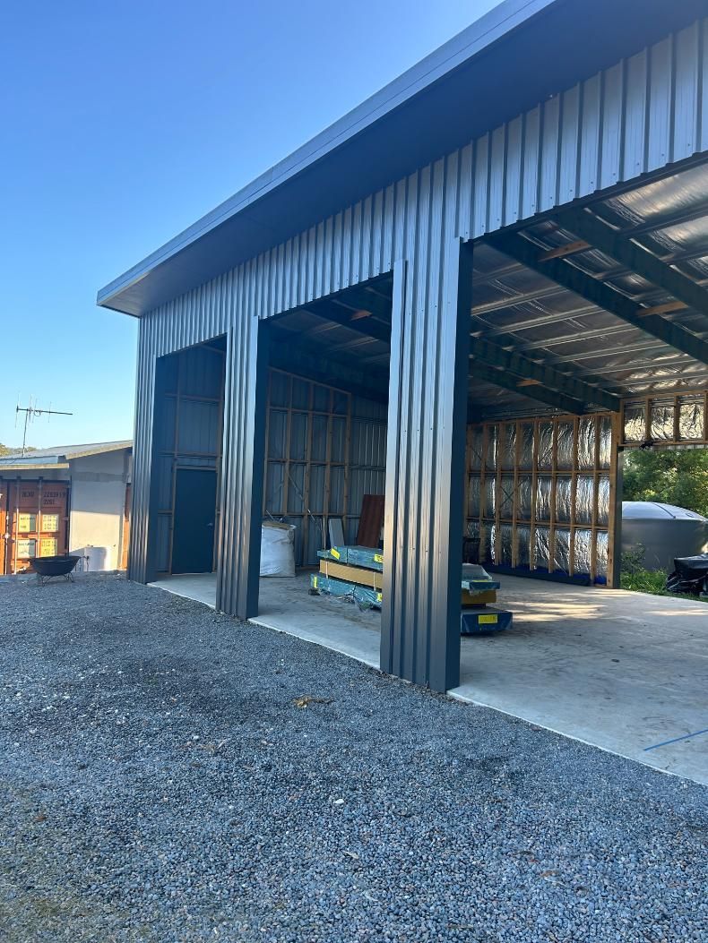 A Large Metal Building With a Lot of Doors Open — P & D Garage Doors in Taree, NSW