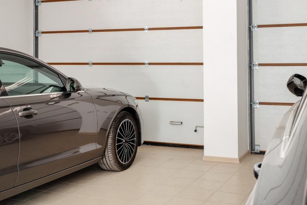 A Car is Parked in a Garage Next to a Garage Door — P & D Garage Doors in Hallidays Point, NSW