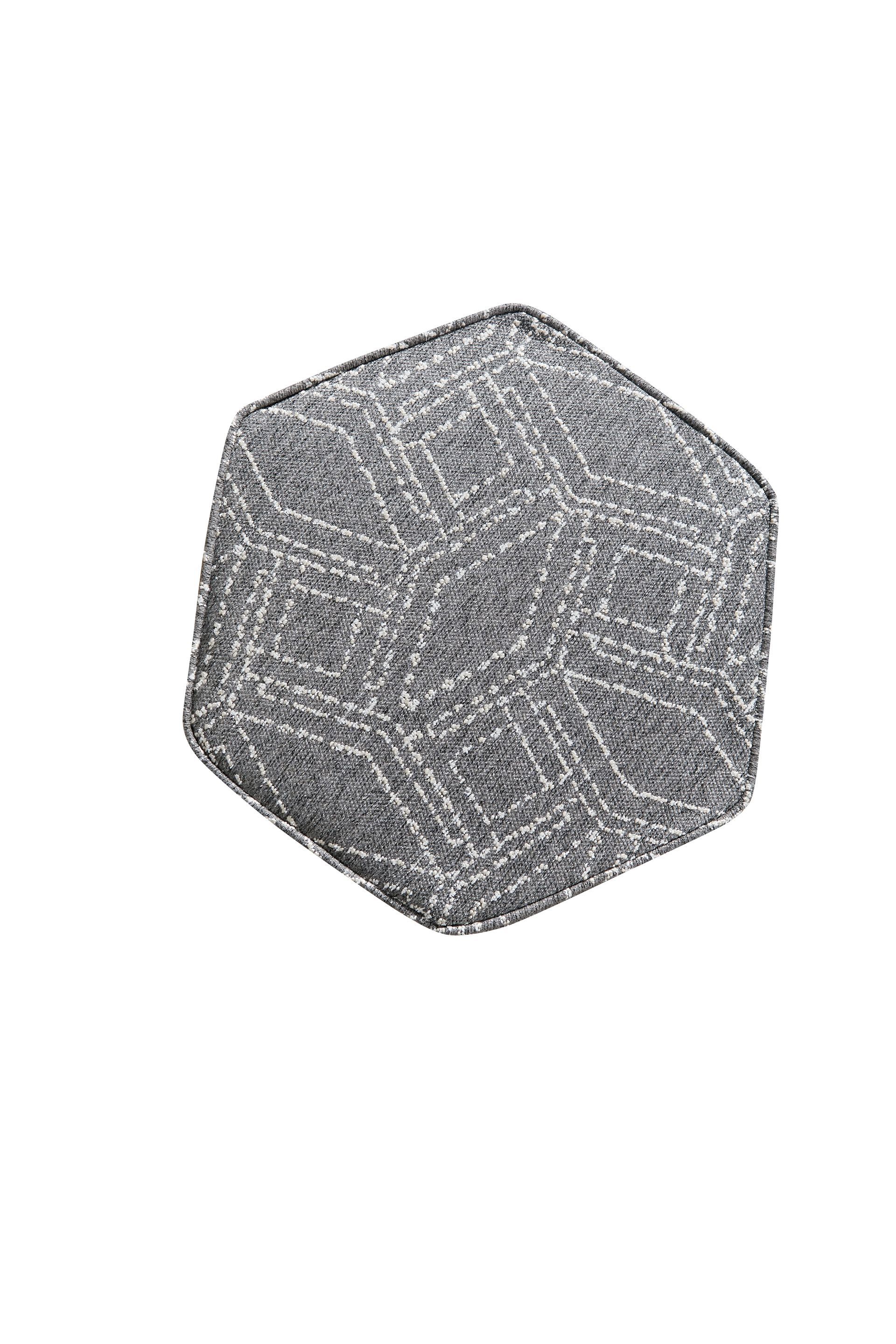 A close up of a gray cube on a white background.