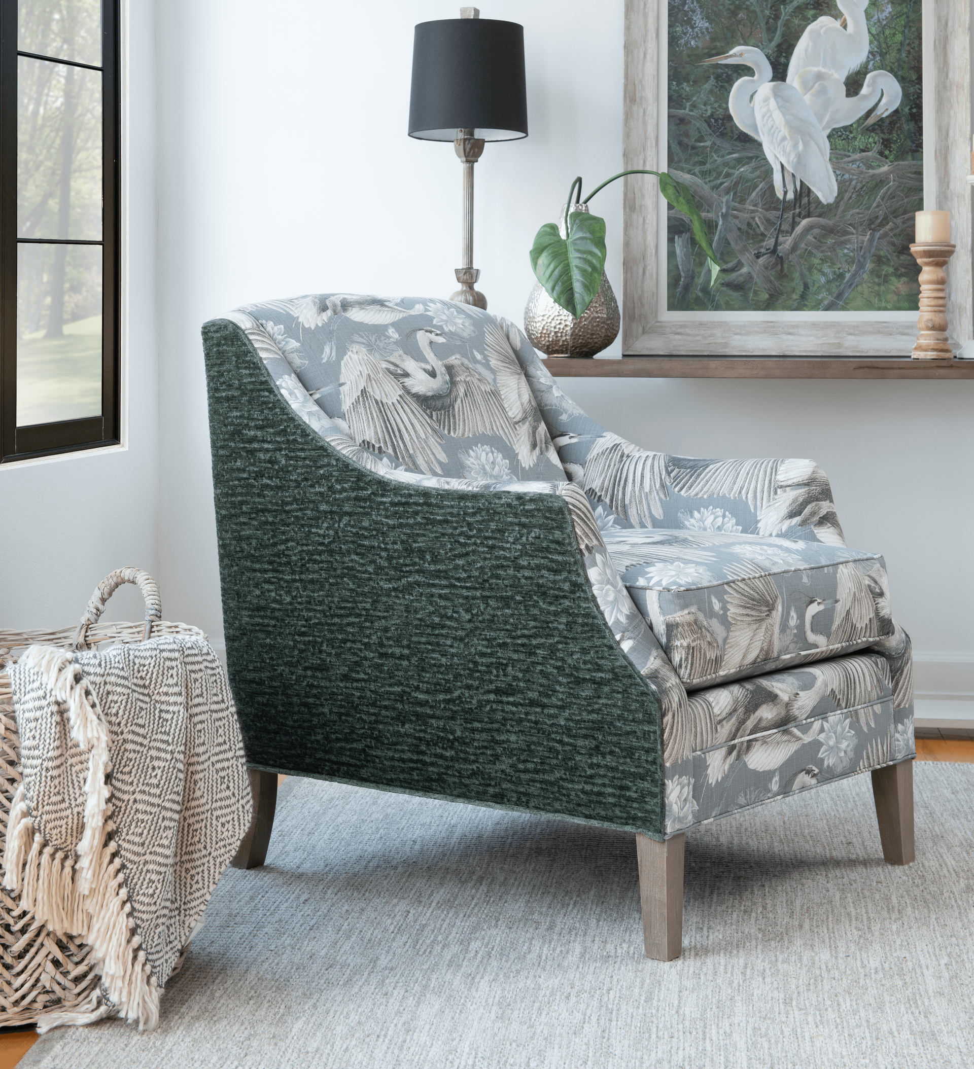 A chair is sitting in a living room next to a lamp.