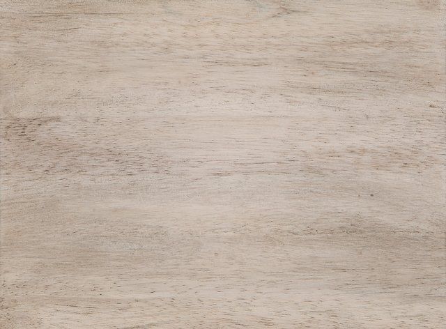 Light-toned wooden surface with visible grain patterns.