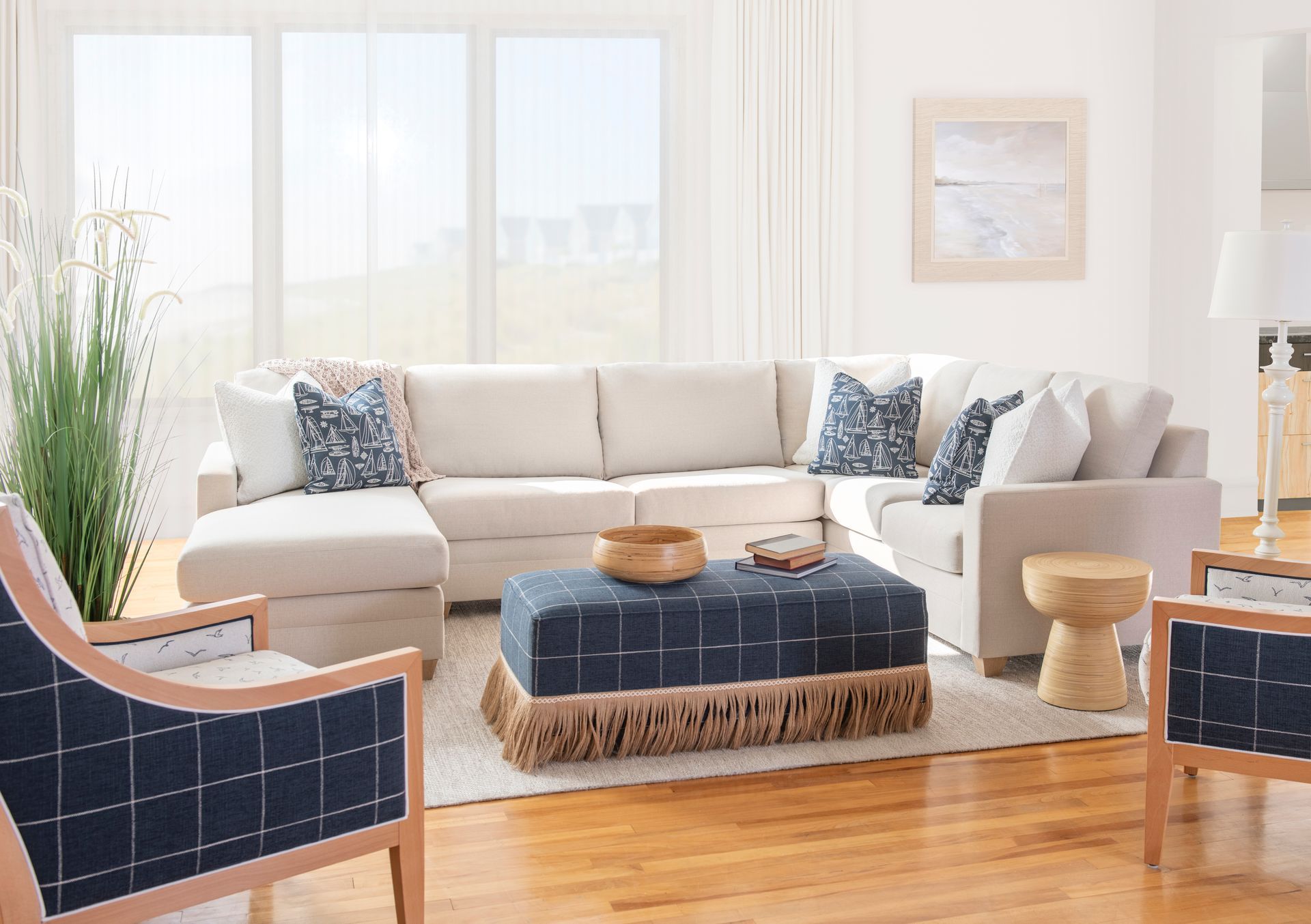 A living room with a large modern sectional couch and a rug.