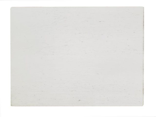 White rectangular block with some small dark specks.