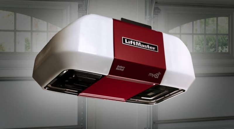 LiftMaster garage door opener, white and red, installed in a garage.