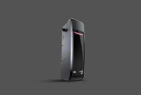 Black, rectangular device with a screen and buttons on a gray background.