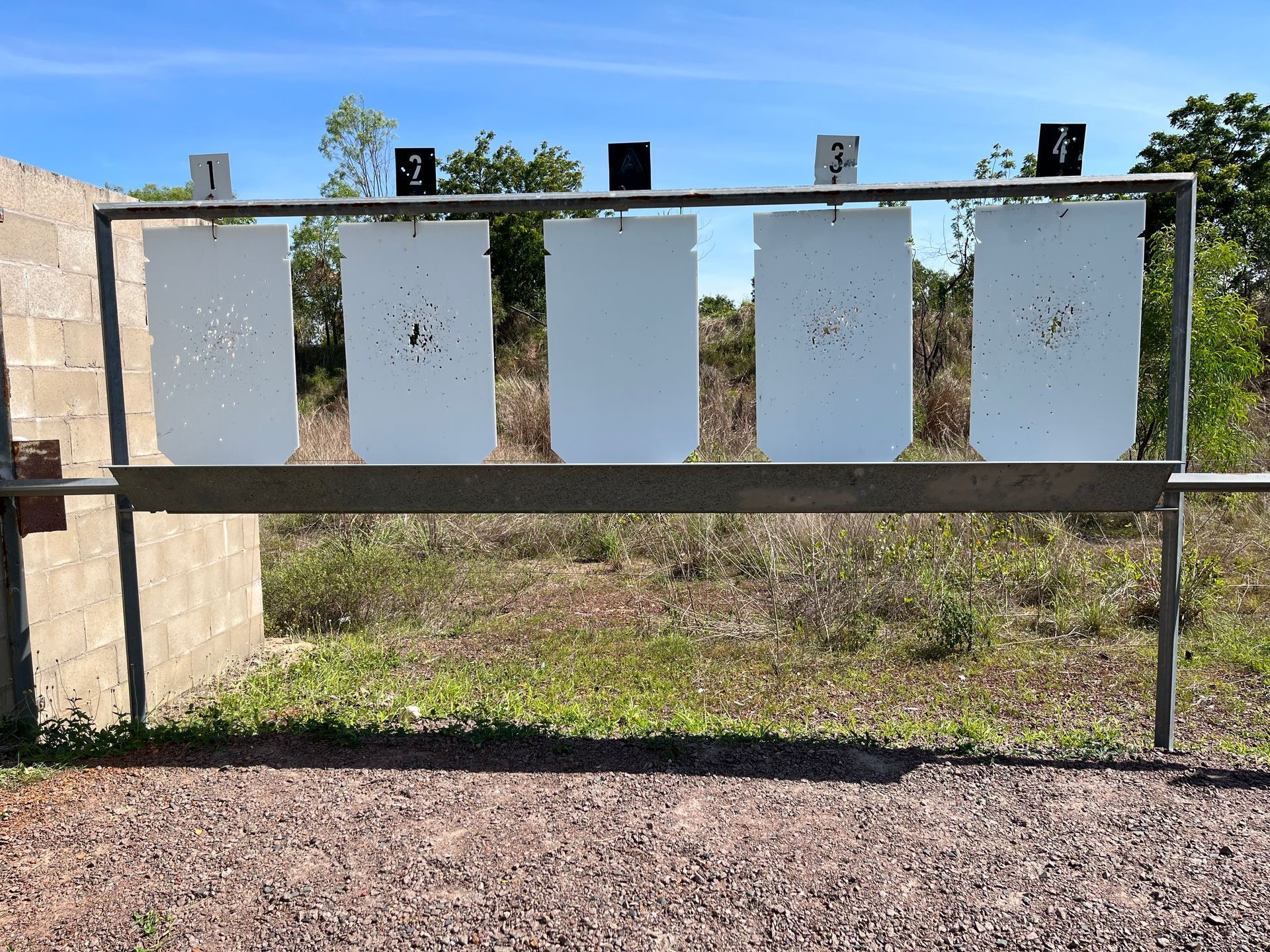 Outdoor Shooting Target Stand With Five Hanging White Metal Plates — Greville Fabrication in Girraween, NSW