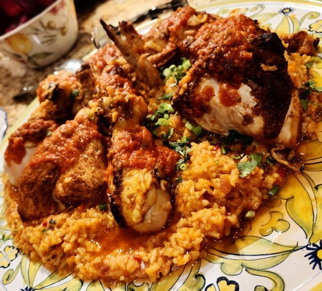 A plate of food with rice and chicken on it