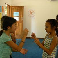 Two young girls are standing next to each other in a room.