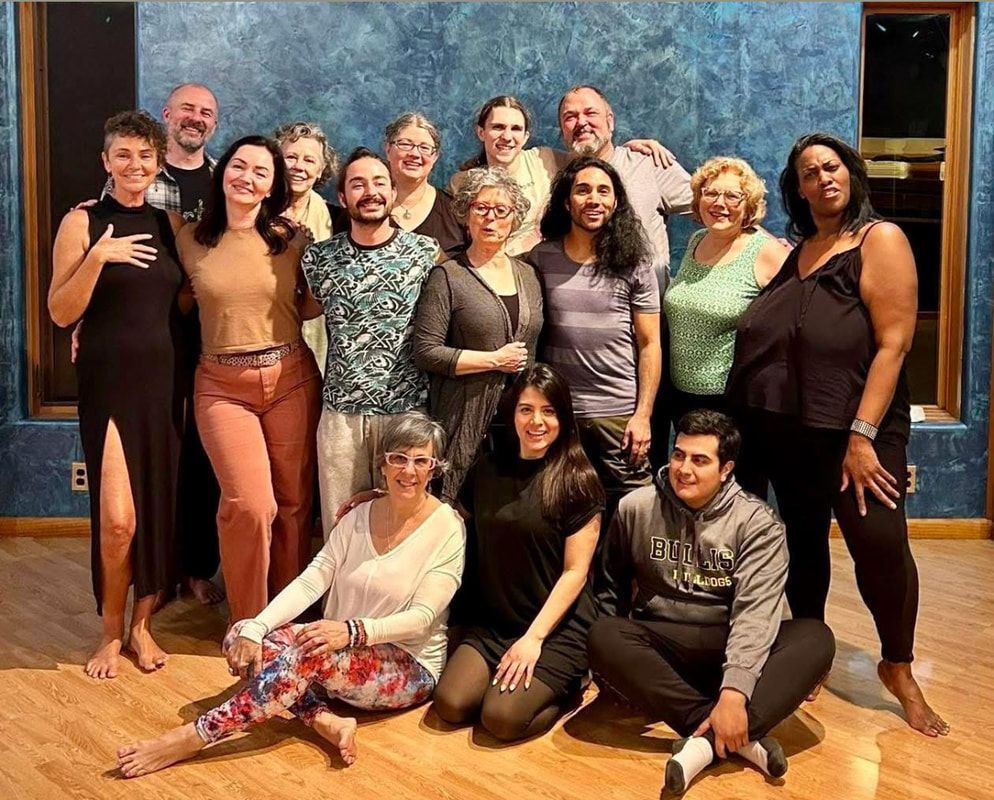 A group of people are posing for a picture in a room.