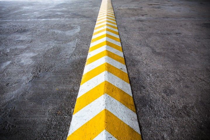 A Yellow and White Arrow Painted on the Side of a Road — Payton Civil Products in Gatton, QLD