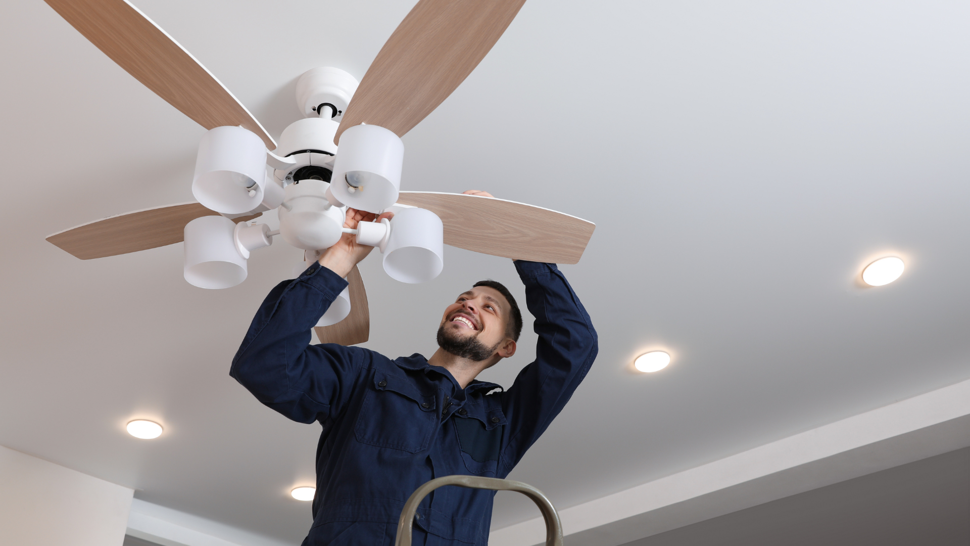 Professional ceiling fan installation service with licensed installer mounting and wiring a residential ceiling fan safely