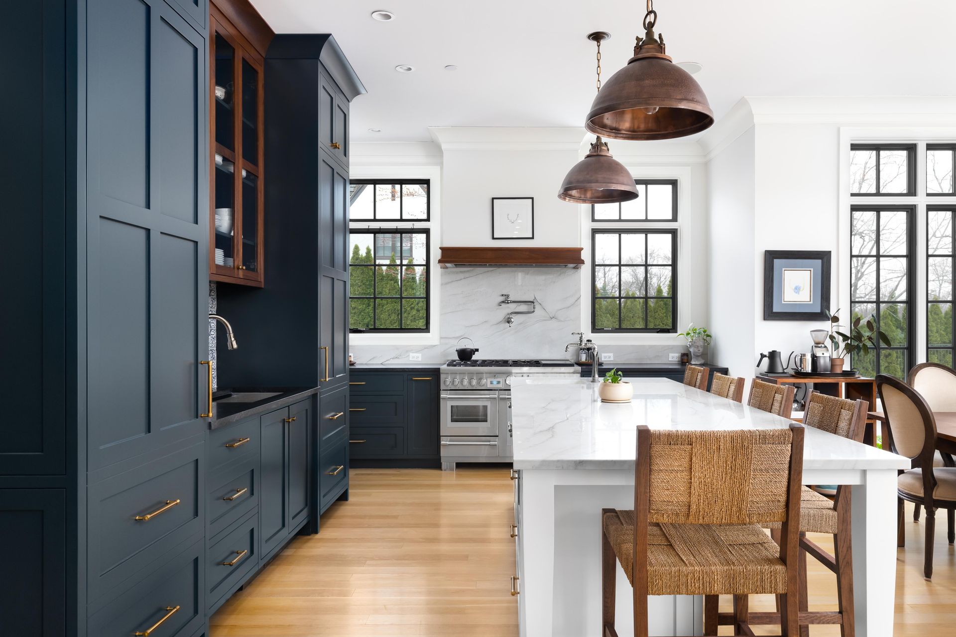 a kitchen with blue cabinets , white counter tops , and a large island .
