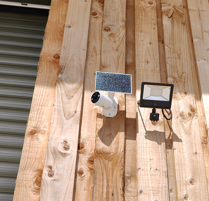 TP-Link Tapo C410 solar camera with panel installed on wooden fence for remote property surveillance