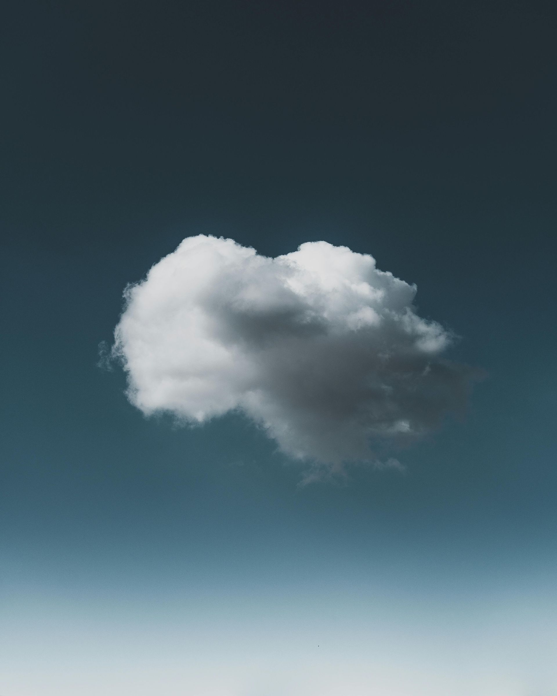 Fluffy white cumulus clouds floating in a clear blue sky, symbolizing cloud computing and modern sec