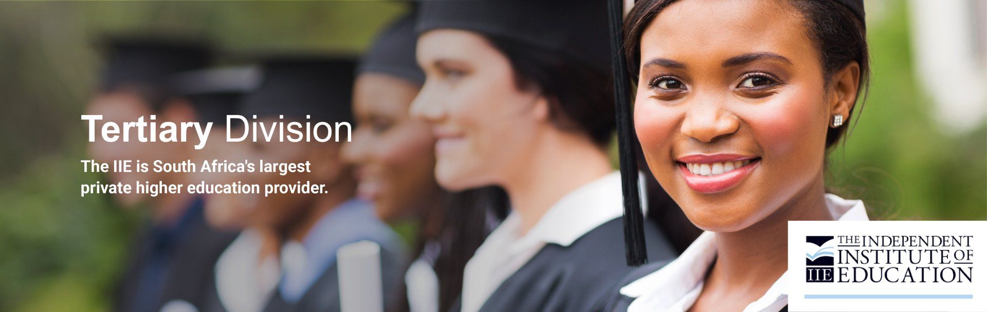 A woman in a graduation cap and gown is smiling