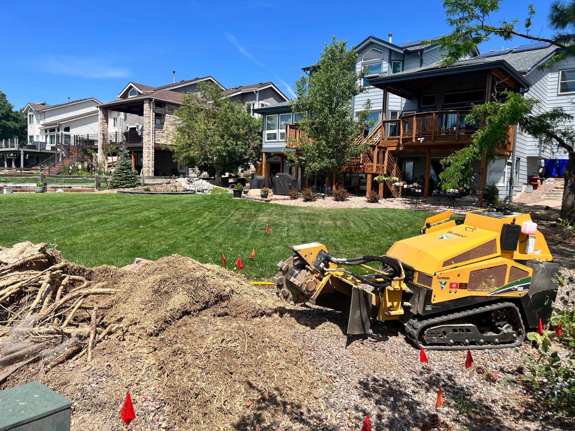 A yellow excavator is working on a dirt field.