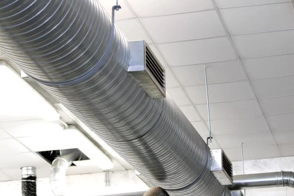 A Large Metal Pipe is Hanging From the Ceiling of a Room — Northside Air Conditioning Services In Aspley, QLD
