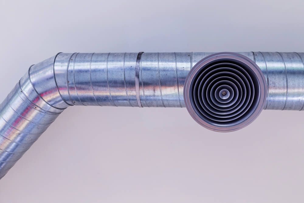 A Close Up of a Metal Pipe With a Round Hole in the Middle — Northside Air Conditioning Services In Ascot, QLD