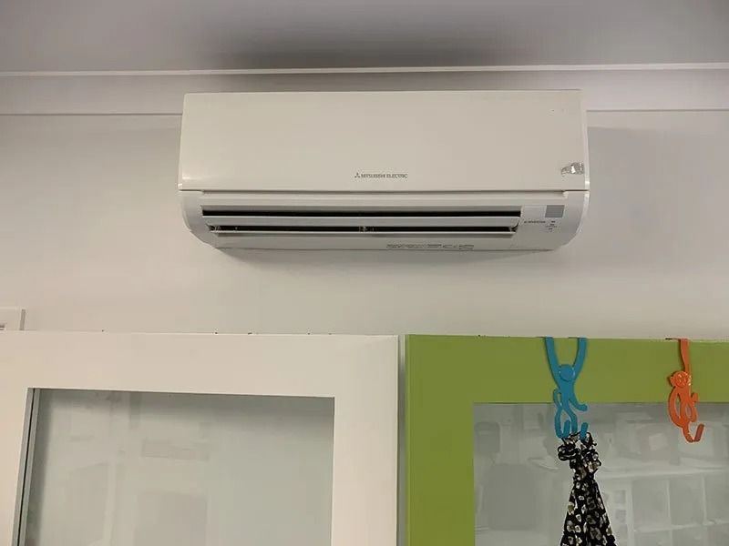 A White Air Conditioner is Hanging From the Ceiling — Northside Air Conditioning Services In Aspley, QLD