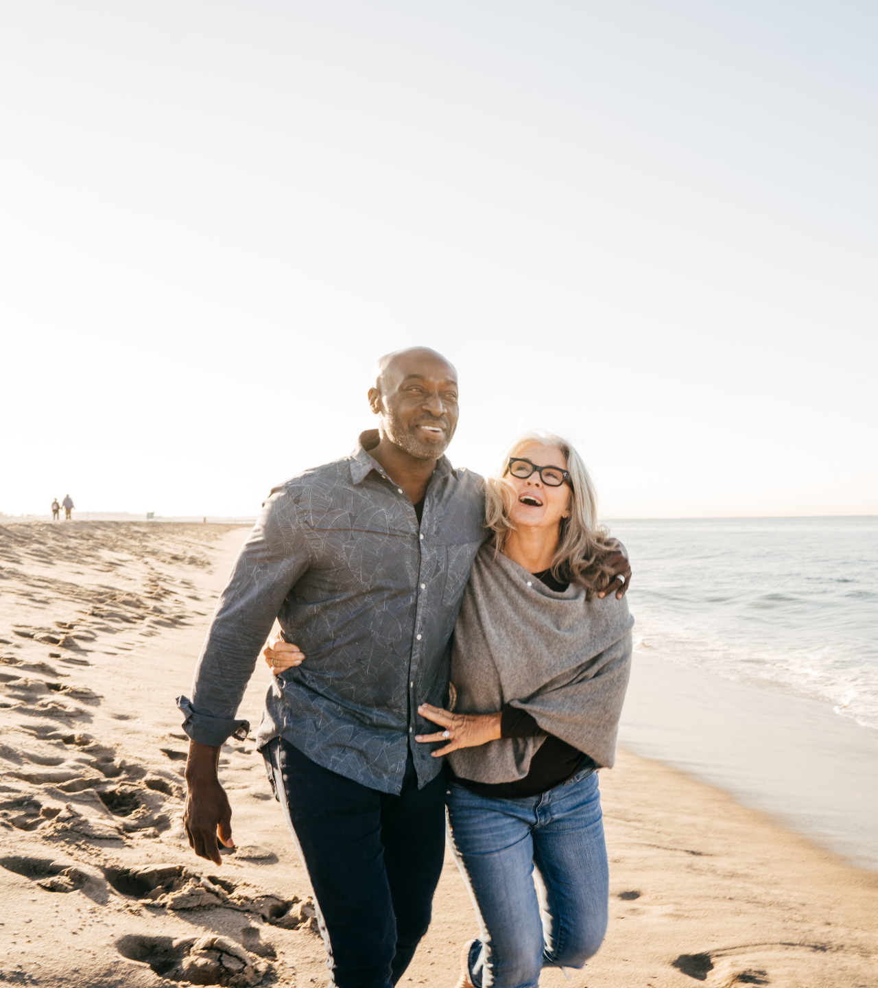A man and a woman are standing next to each other and smiling.