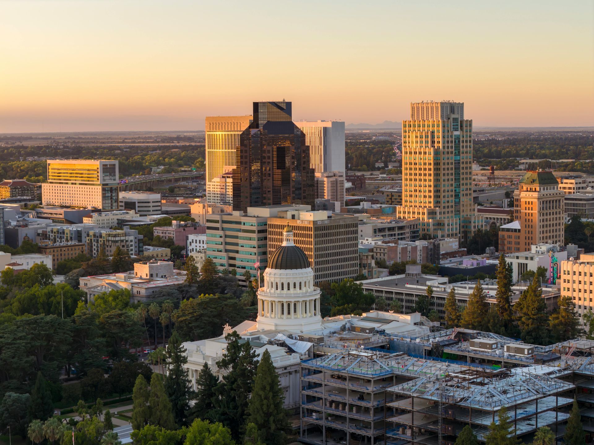 Sunset view of Sacramento skyline with the State Capitol building in foreground.