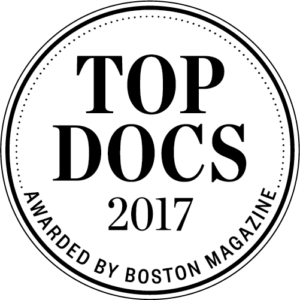 Top Docs award badge from Boston Magazine, 2017. Black text on white circle.