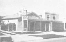 Black and white photo of a small building,