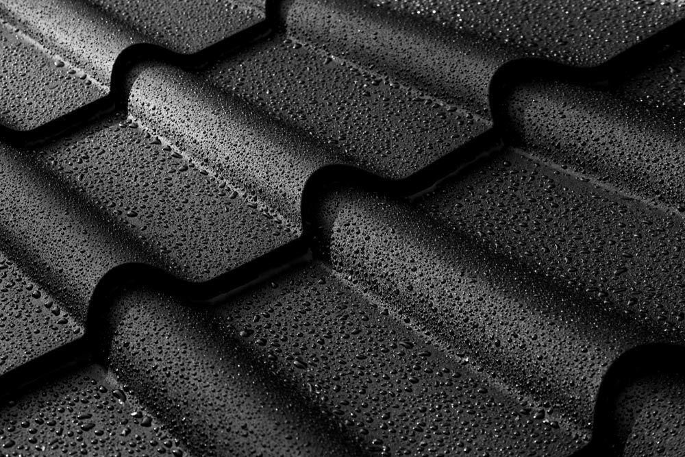 Water Droplets On Black Metal Roof — Experienced Roofer in Ipswich, QLD