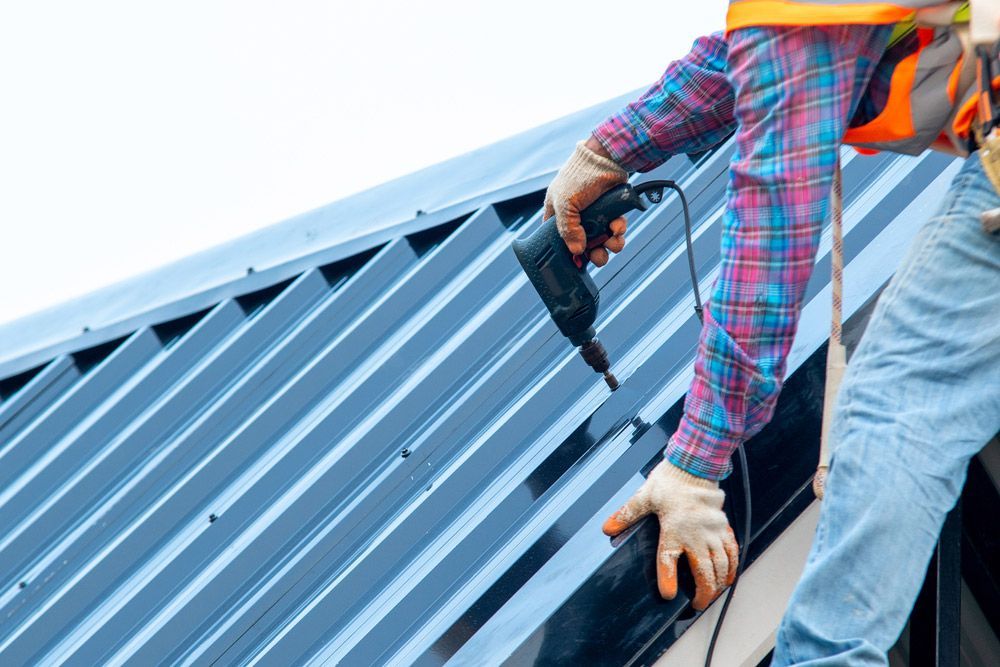 Roofer With Electric Drill — Experienced Roofer in Brisbane, QLD