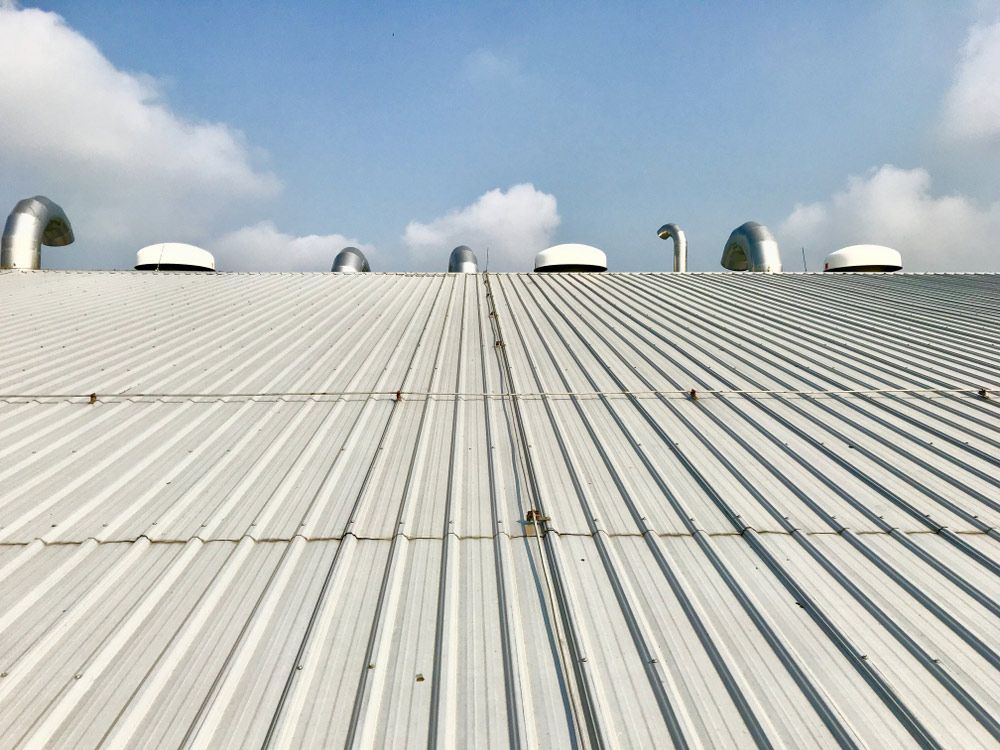 White Metal Roof Of Commercial Building — Experienced Roofer in Dalby, QLD